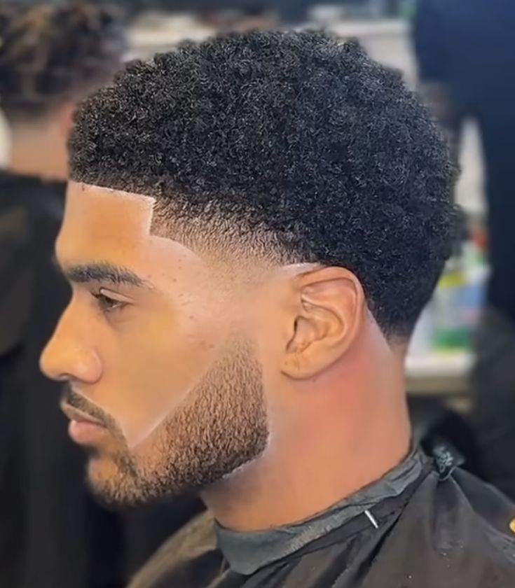A sharp taper fade with a lined up beard