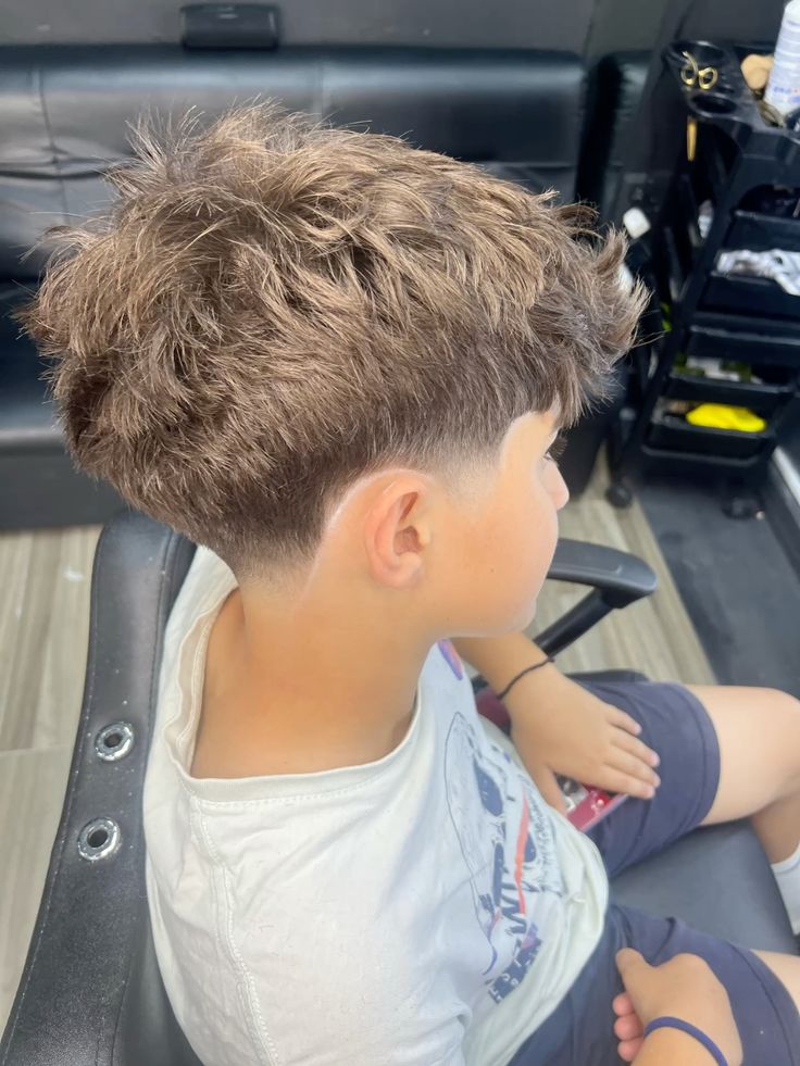 A young client with a fresh textured cut and clean taper