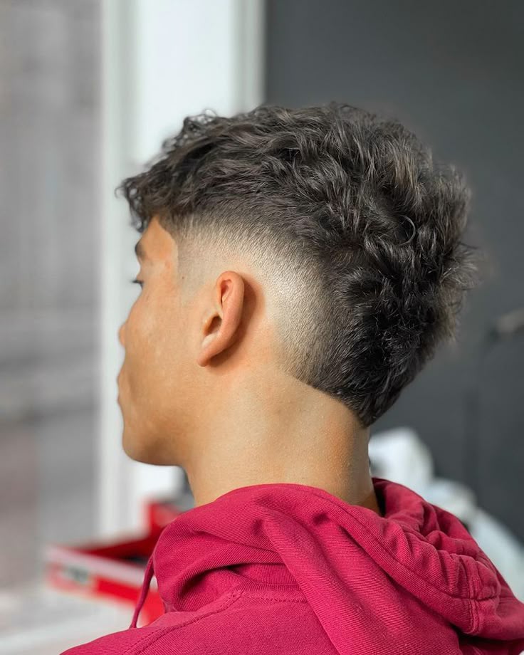 A curly taper fade seen from the side