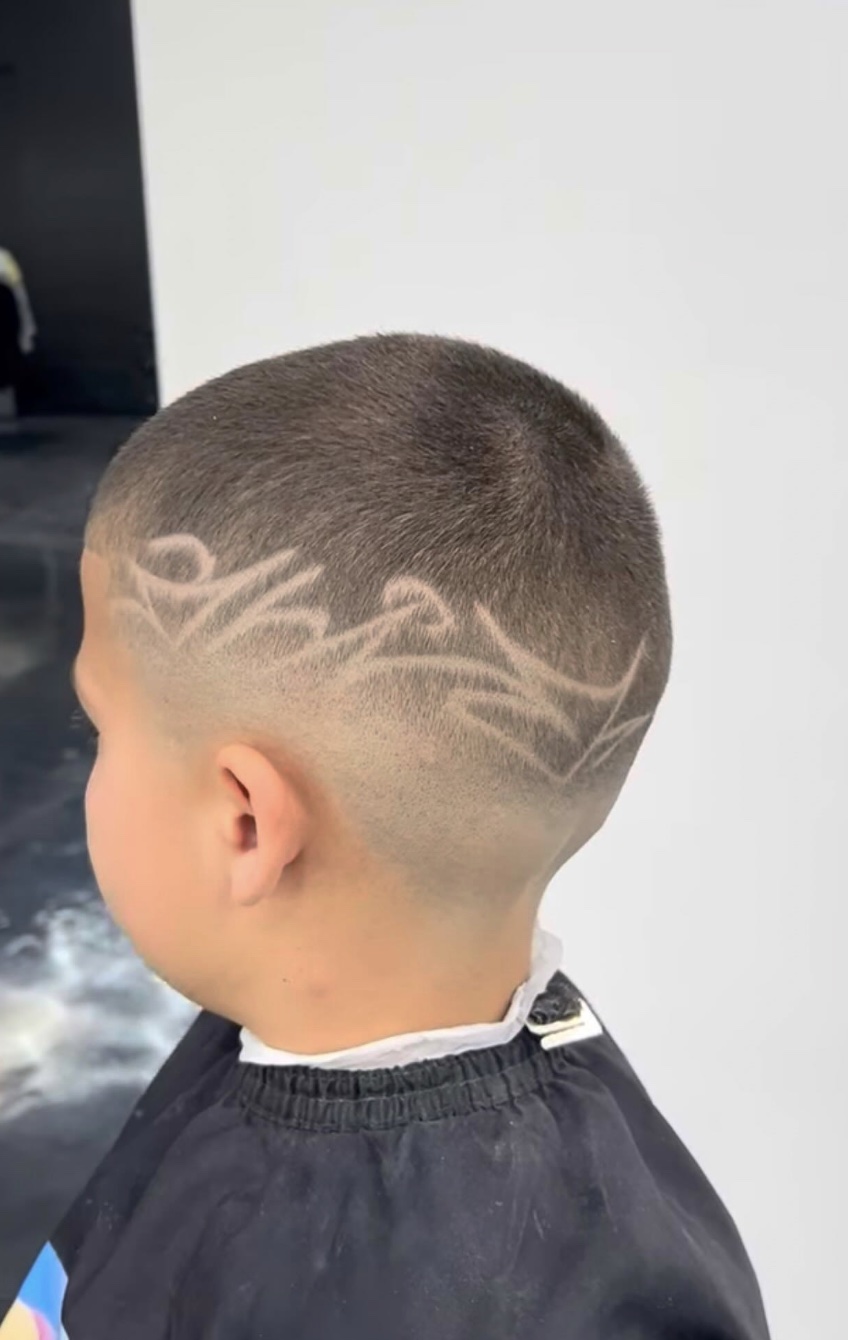 A tribal freestyle design carved into a kids buzz cut
