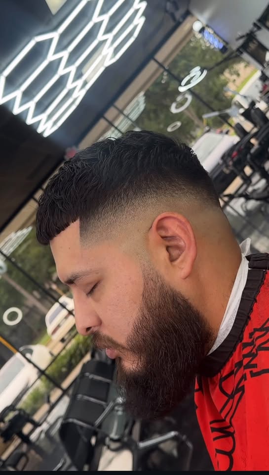 A crisp mid fade with a full sculpted beard at Authentic Cutz