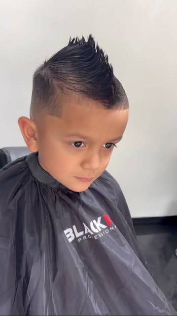 A kid's spiked fade with a clean lineup