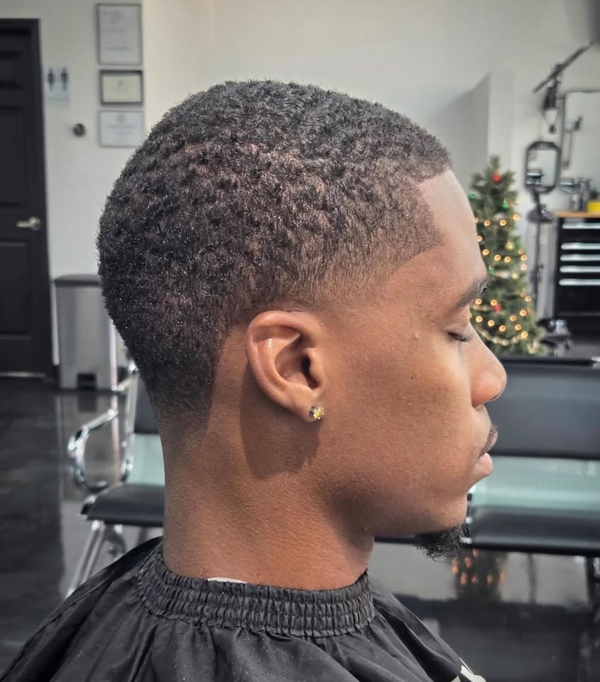 A natural taper fade with a sharp part