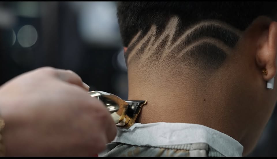 A freestyle design shaved into the back of a fade