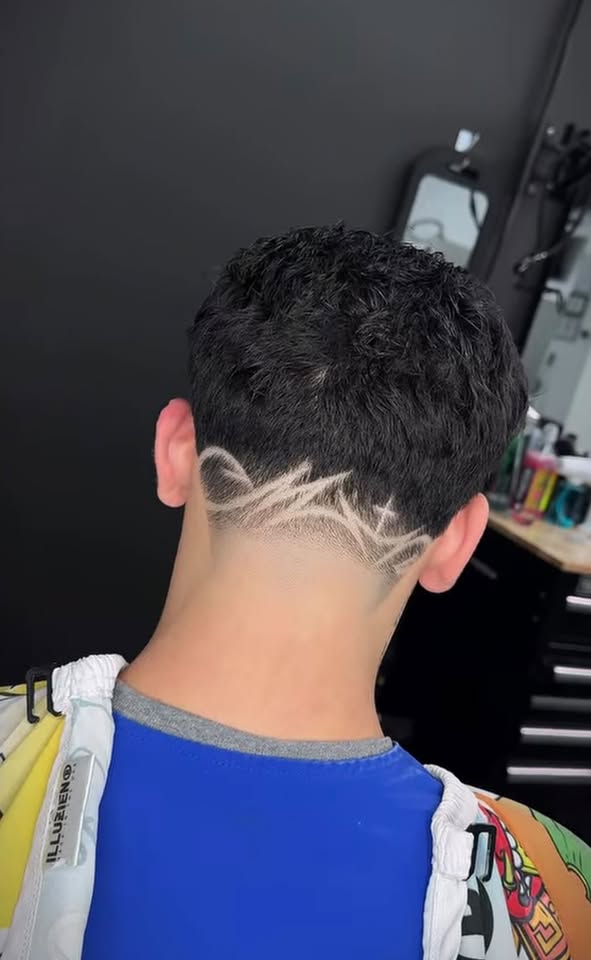 A freestyle star design shaved into the back of a fade