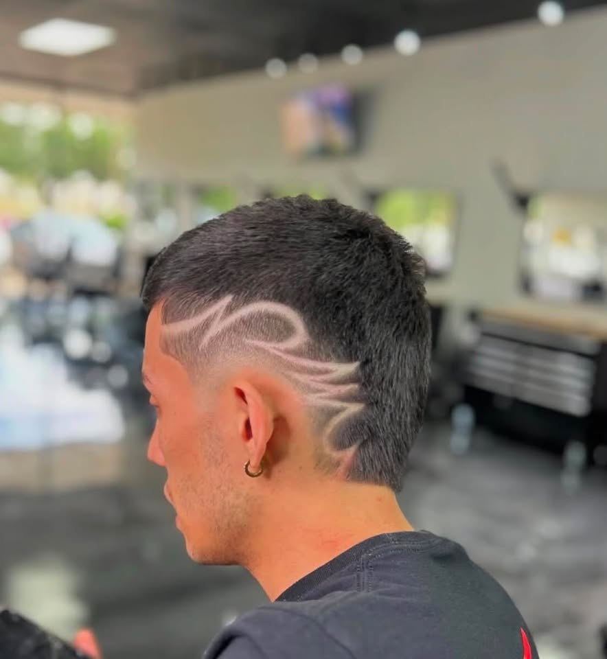 A freestyle swirl design shaved into the side of a fade