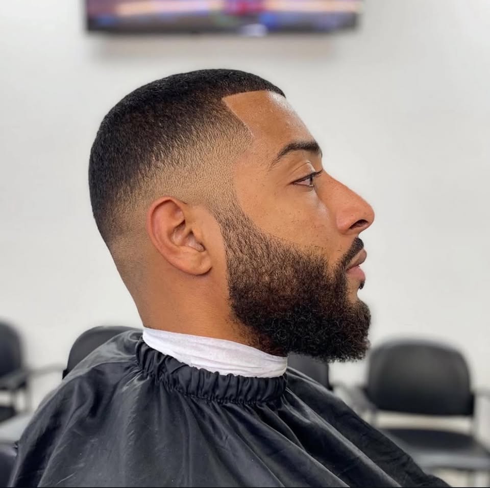 A clean fade with a sharp beard lineup